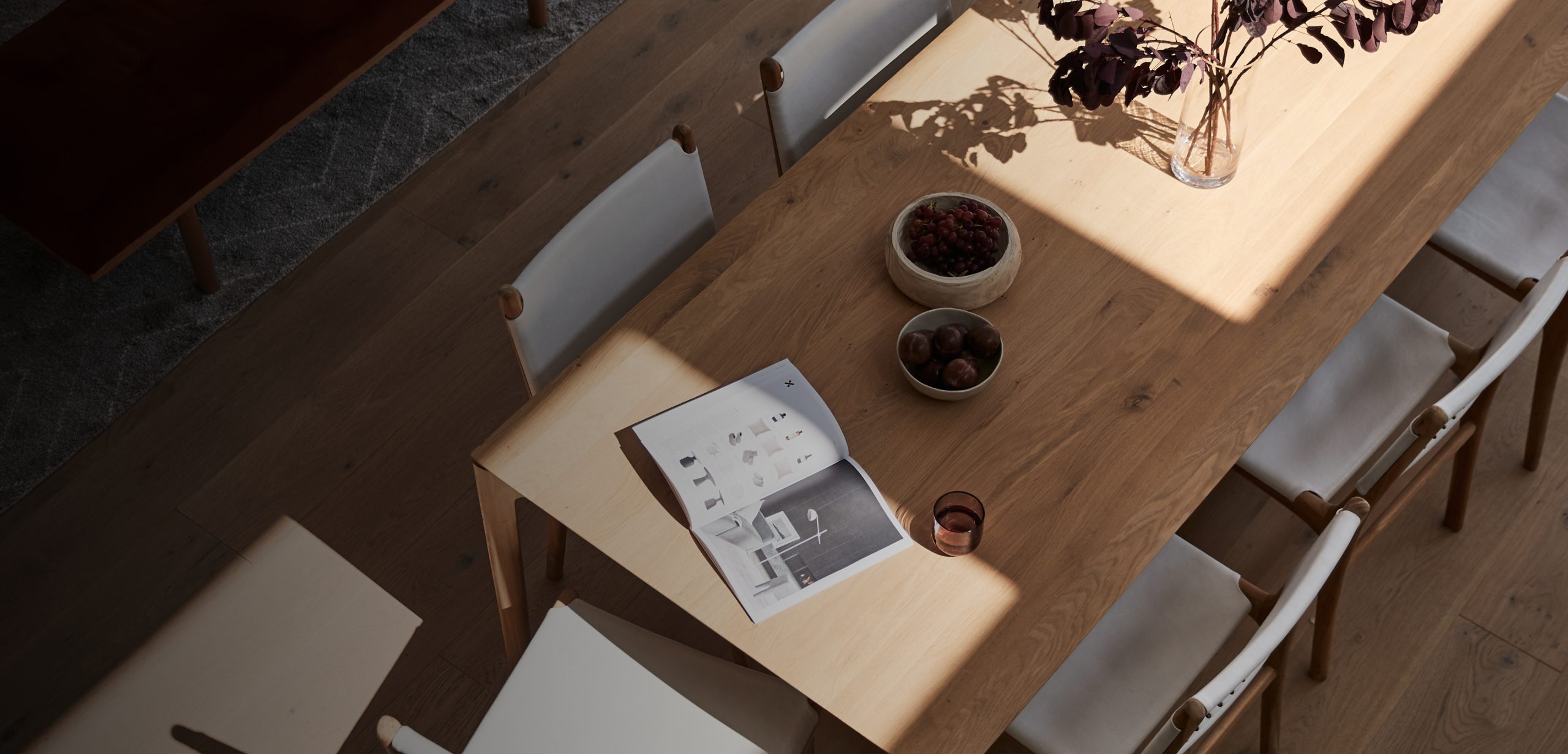 Dining setting with an interior design catalogue open on the table