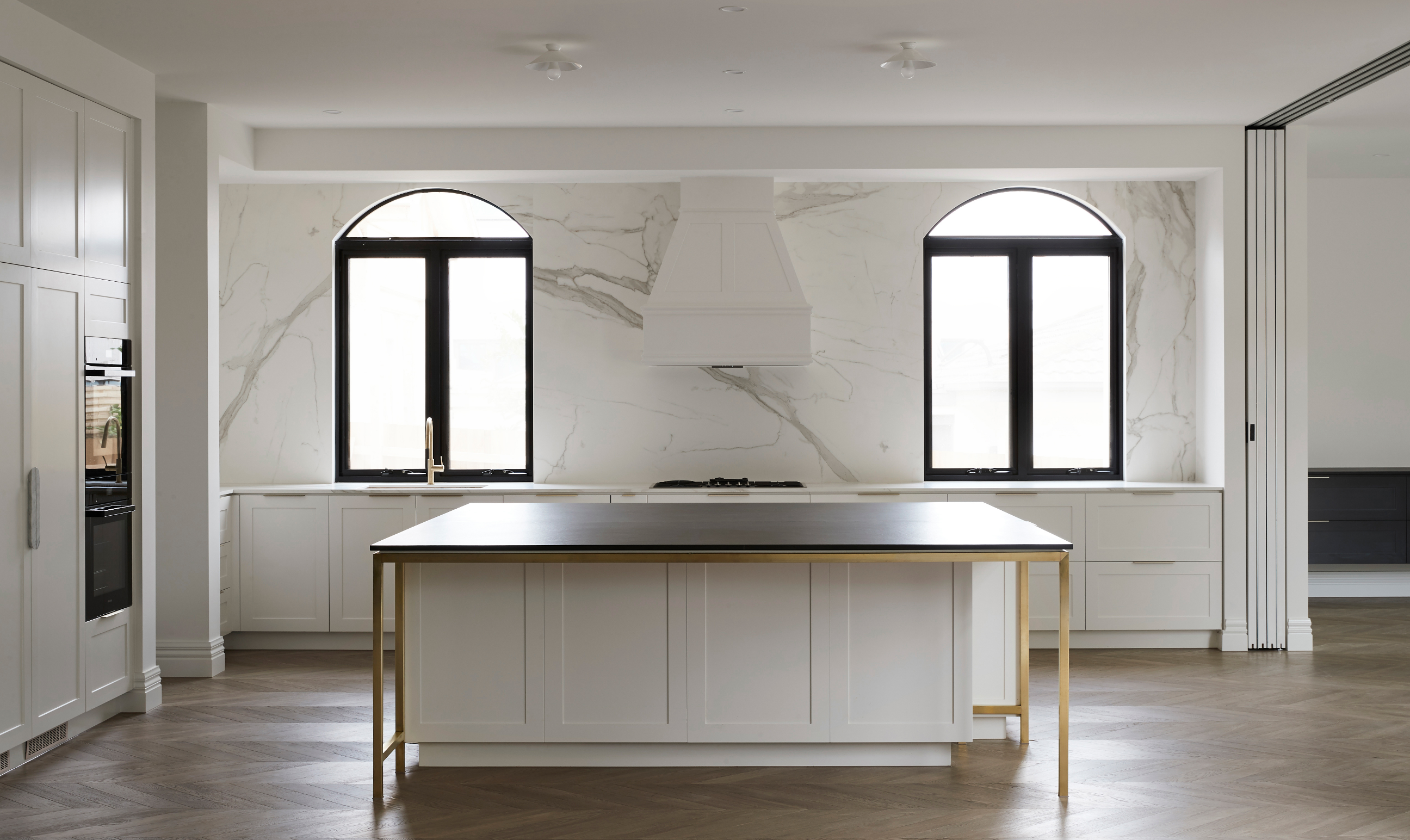 Custom kitchen with all white cabinetry and black accents