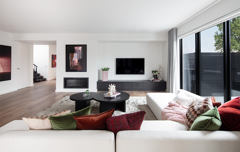 Living area with couch, coffee table, TV, and glass sliding doors to the outdoor area