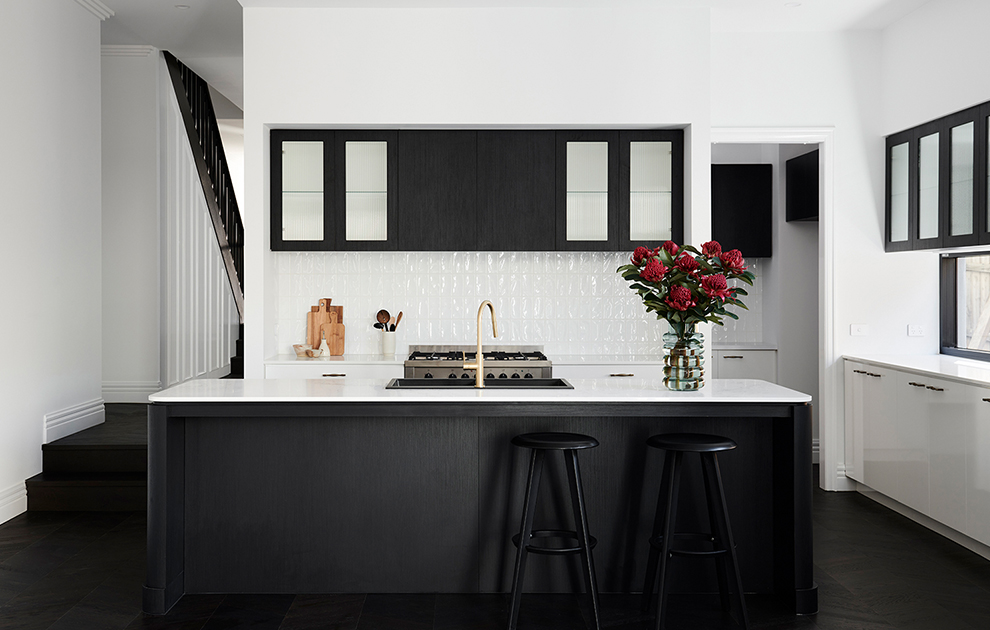 Modern kitchen with black cabinetry and white tile & bench tops