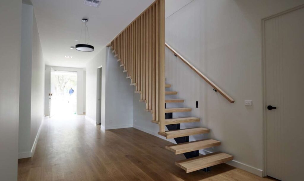 Bright entry hallway and timber staircase leading to second storey