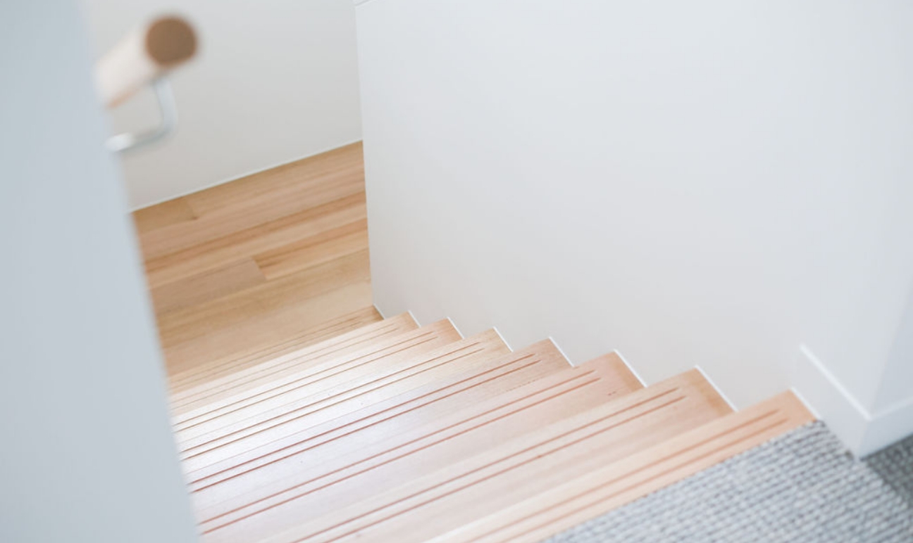 Timber staircase leading down to lower storey