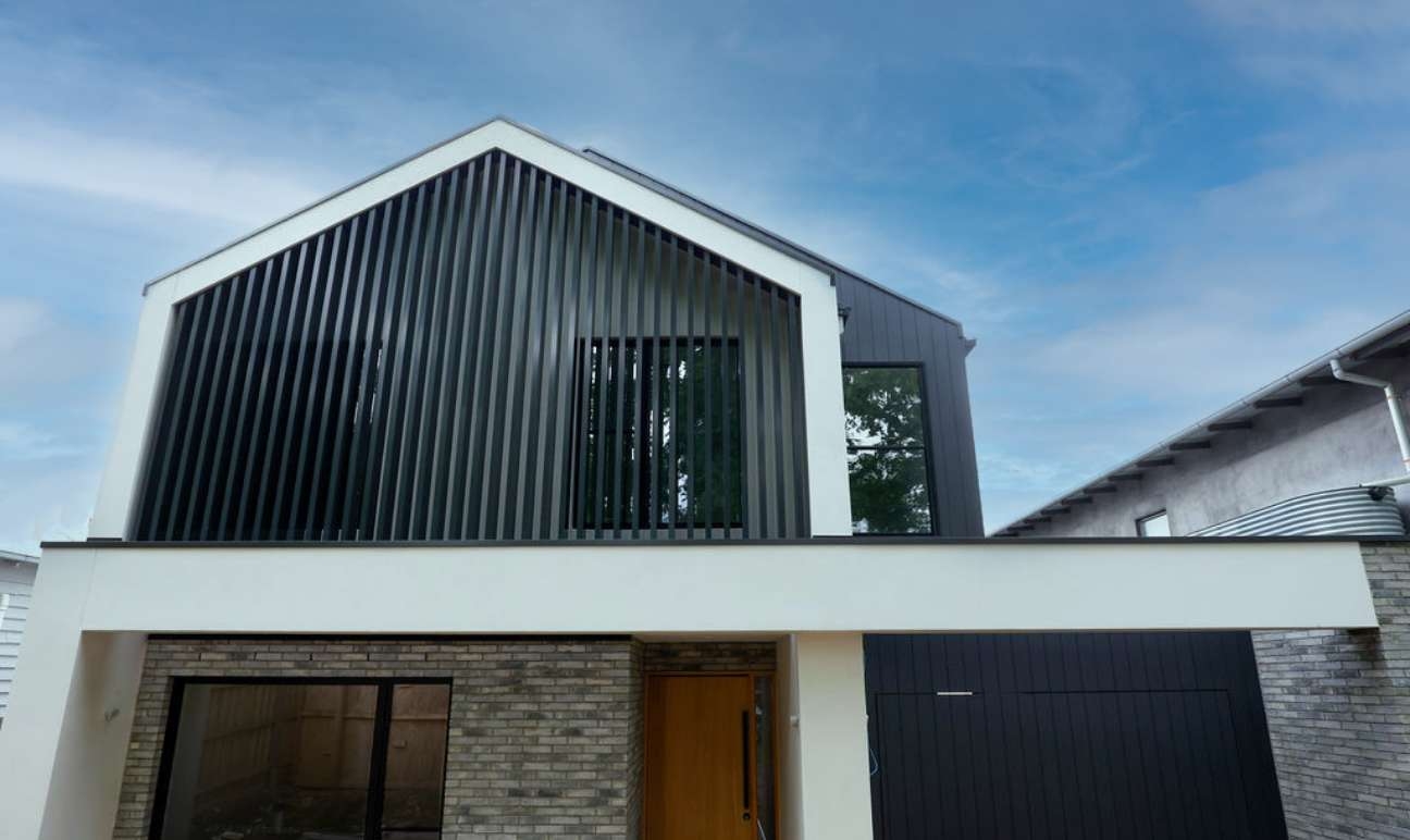 Double-storey facade with black & white exterior and brick detail