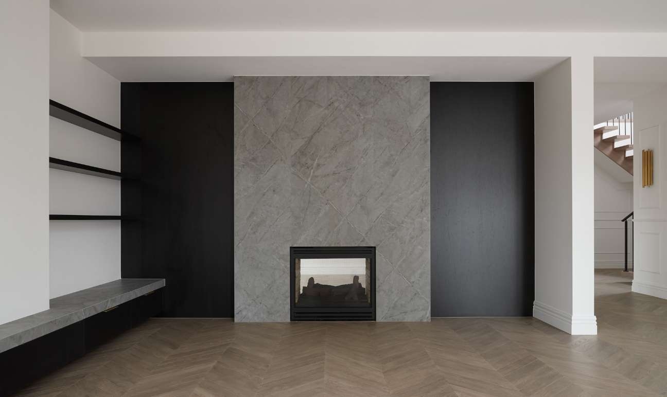 Sitting room showcasing multiple finishes across built-ins, fireplace, bench top and flooring