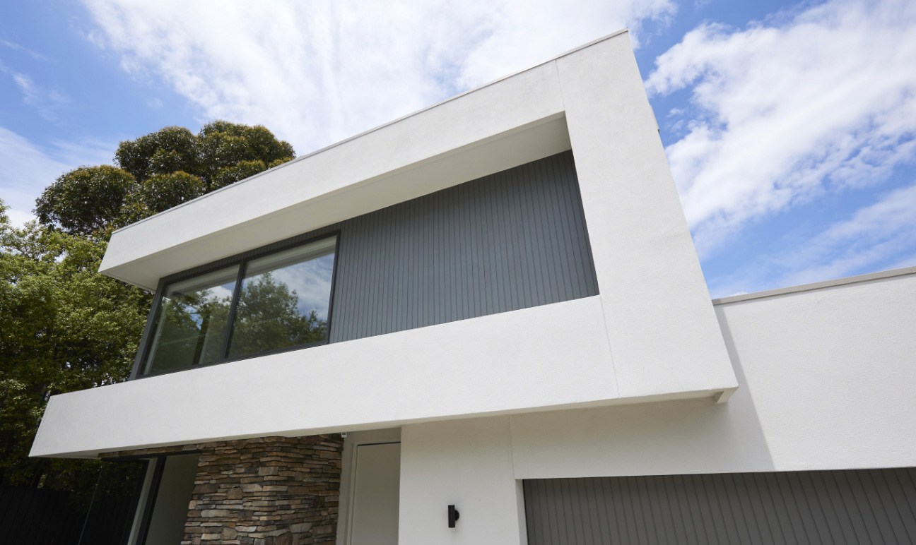 Double storey facade against blue sky with clouds