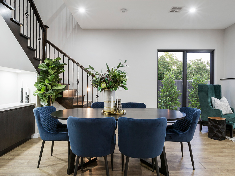 Dining area with dark table and chairs, built-in cabinetry and indoor plants