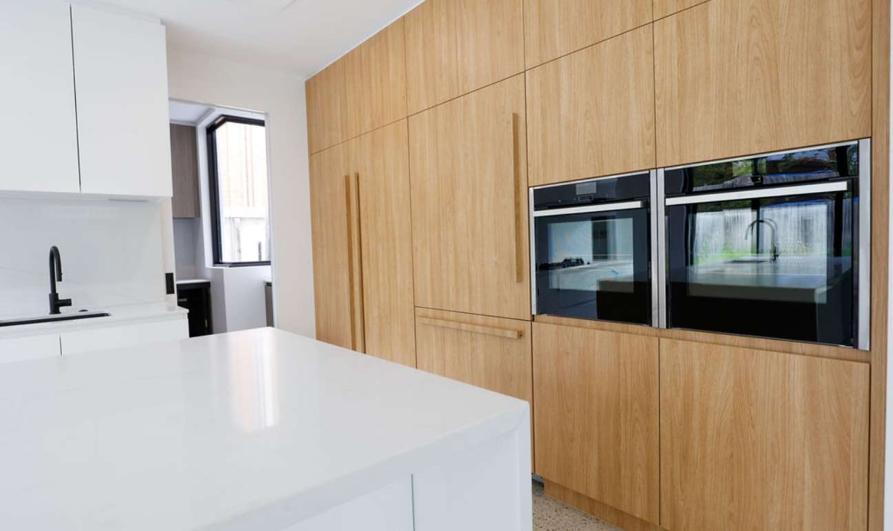 Timber finish kitchen cabinetry and integrated appliances