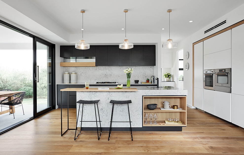 Modern kitchen with grey stone finishes, mixed cabinetry with timber accents