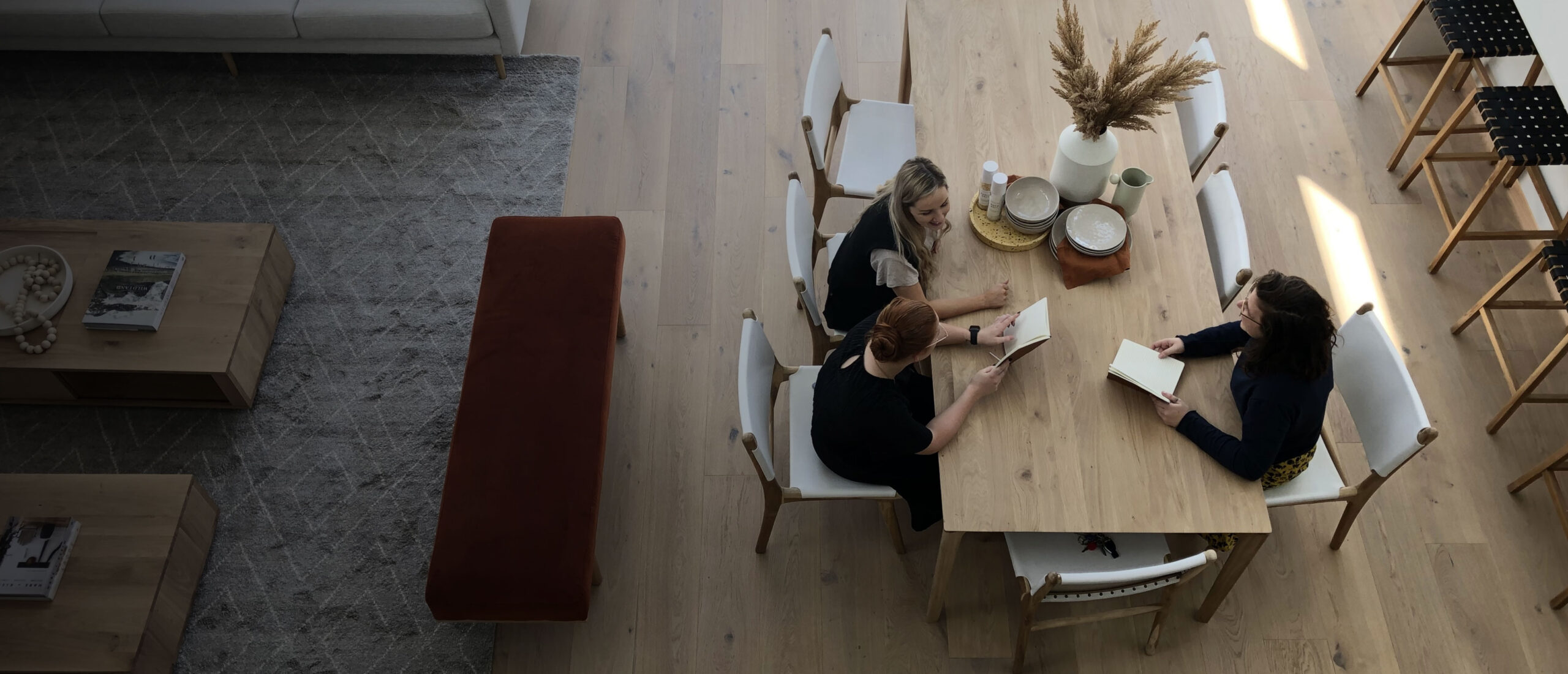 Dining setting with an interior design catalogue open on the table