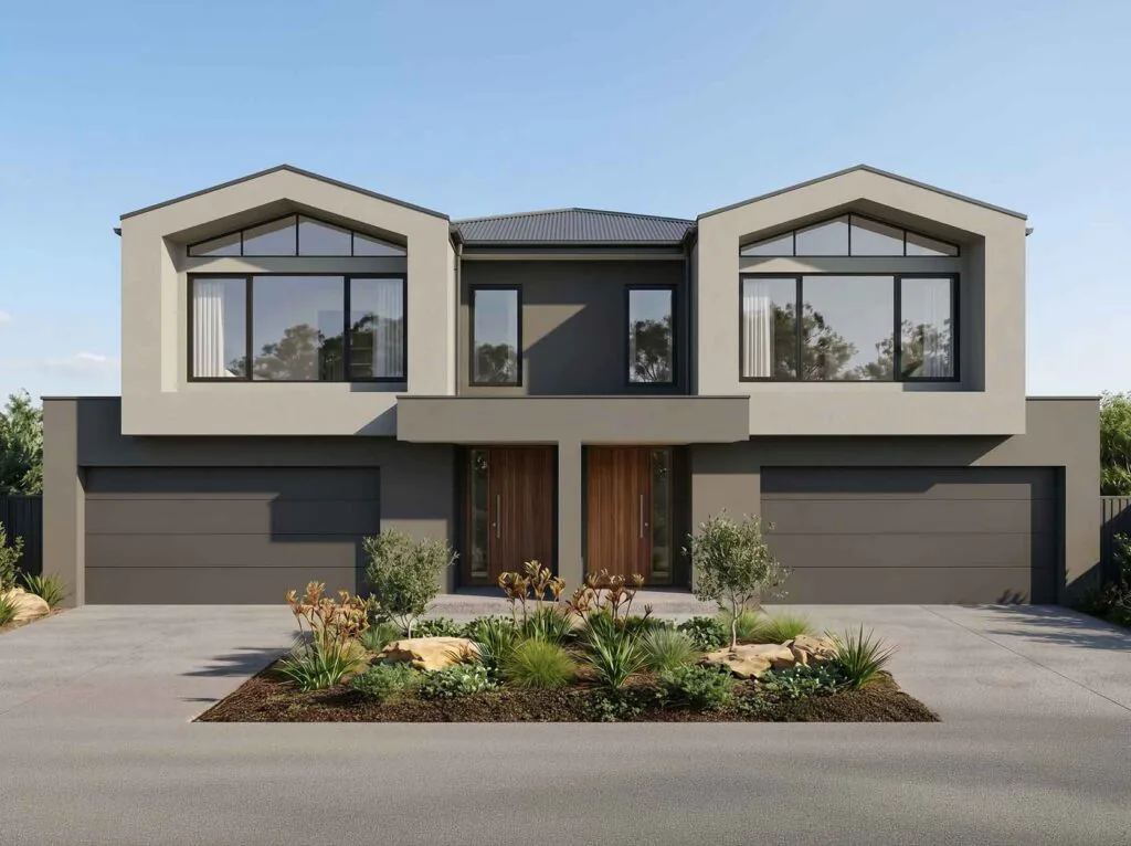 Modern two-story duplex with dark gray and beige facade, two garages, and a landscaped front yard under a blue sky