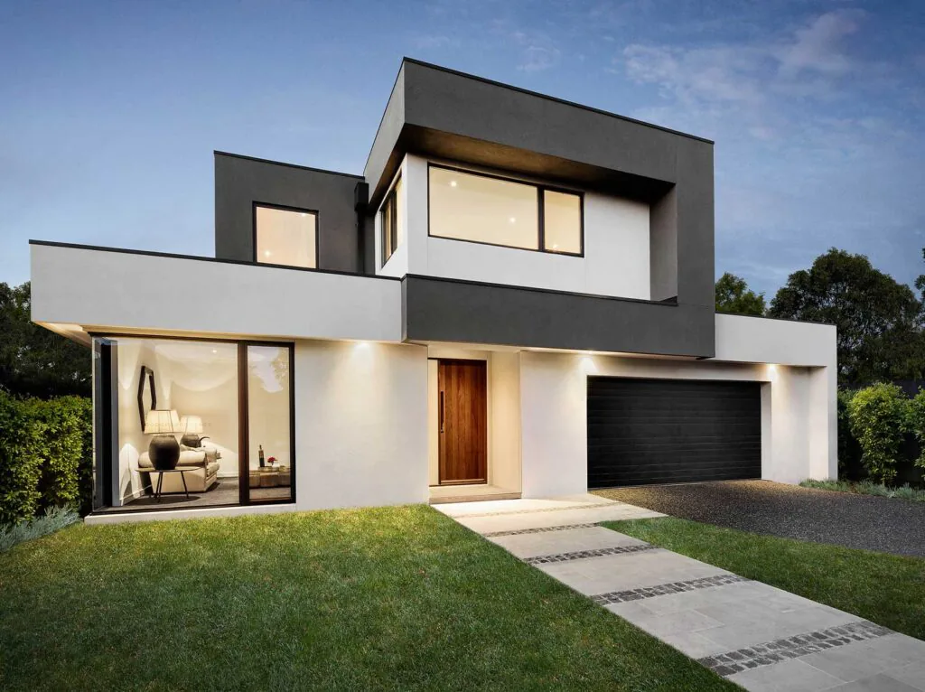 Modern two‑story house with white and dark gray facade, large front window, wooden entry door, and black garage door.