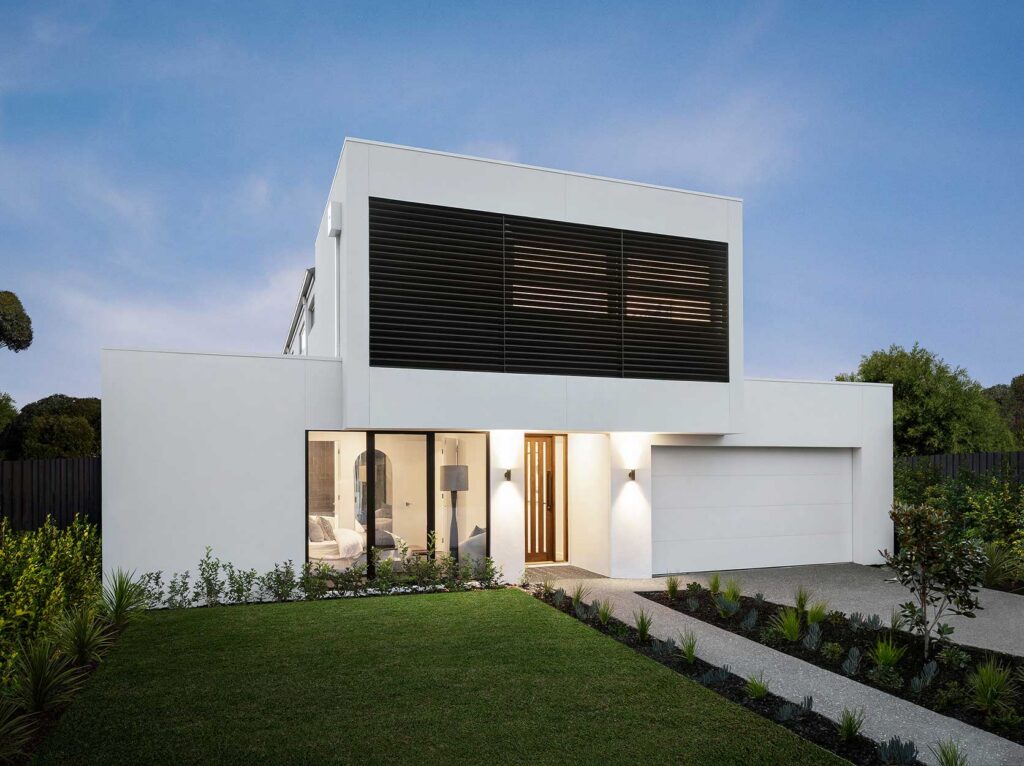 Modern white two-story house with black horizontal louvers and a glass front entrance, surrounded by a manicured lawn.